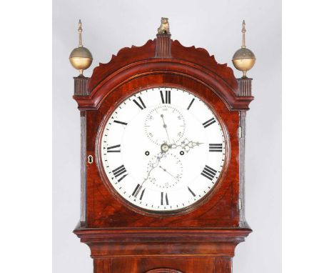 An early 19th century figured mahogany longcase clock with eight day movement striking on a bell, the 12-inch circular white 