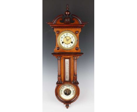 An early 20th century German walnut cased wall clock with aneroid barometer and mercury thermometer, the eight day clock move