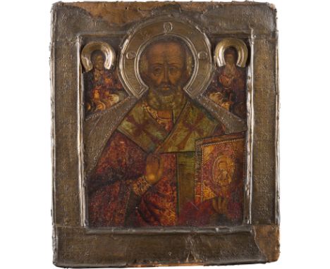 AN ICON SHOWING ST. NICHOLAS OF MYRA WITH BASMA Russian, 18th century Tempera on wood panel with kovcheg. Overlaid with a bra