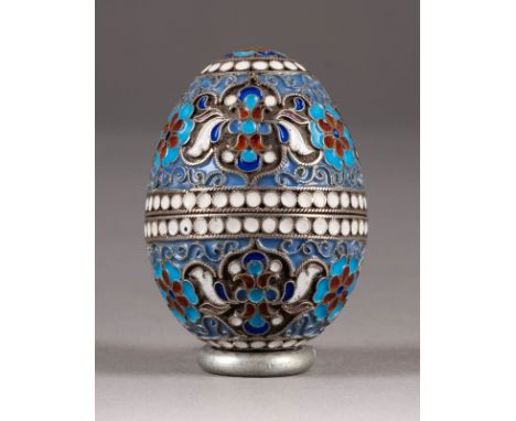 A SILVER AND CLOISONNÉ ENAMEL EGG 2nd half 20th century The ovoid body enamelled with flowers. Bearing spurious Russian hallm