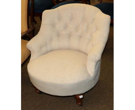 A Victorian button back chair in later cream and blue stripe upholstery 