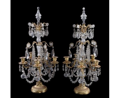 A pair of cut glass and gilt metal five light candelabra in Louis XV style, 20th century, the beaded and swagged sconces abov