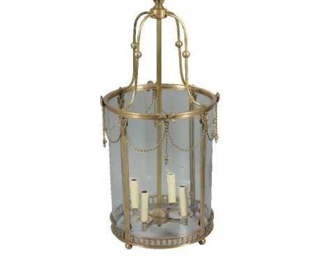 A brass and glazed four light hall lantern, second half 20th century, the four scrolled ceiling supports cast with sphere kno