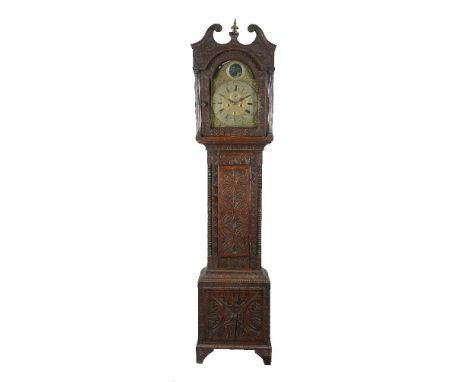 A carved oak longcase clock, the eight-day bell striking movement with 12inch brass arched dial with a moon phase to the arch