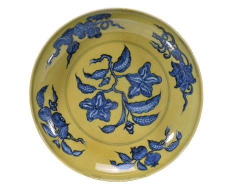 A Chinese underglaze-blue and yellow 'Gardenia' dish, in Ming Style, painted in shaded tones of cobalt with a leafy branch be