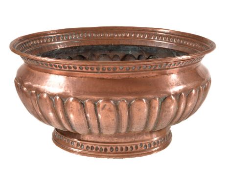 A Continental, probably Italian, repoussé copper wine cistern, 18th century, of oval section, the waisted and everted neck im