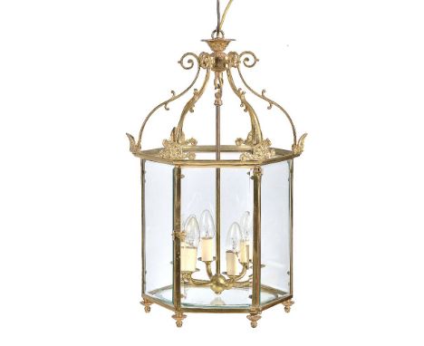 A gilt metal and glazed hexagonal ceiling lantern in Regency taste, 20th century, the six scrolling supports descending to an