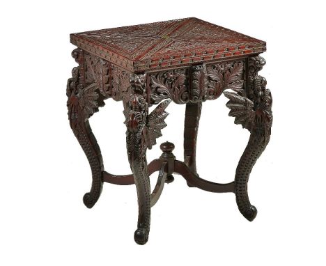 A Chinese carved hardwood envelope card table, late 19th century, the four triangular leaves swivelling and opening to a gree