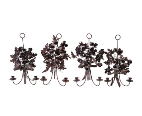 A set of four Italian wrought, pressed and painted metal twin light wall appliques, 20th century, modelled as ribbon-tied bou