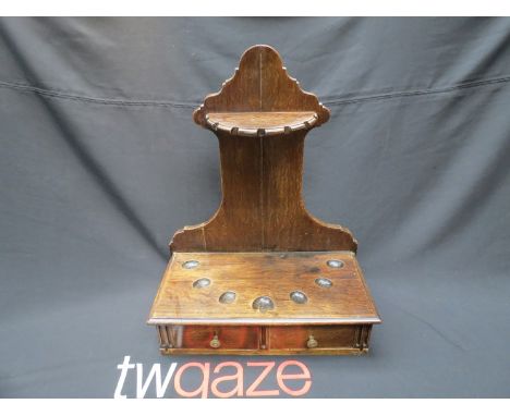An oak wall-hanging church warden's pipe stand with two drawers beneath 