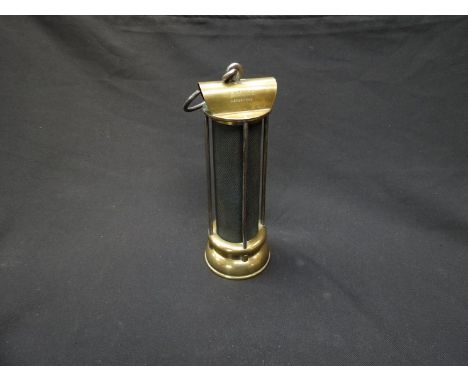 A Stephenson miner's lamp marked "I. Mills Newcastle" brass base and top and four side bars protecting gauze, rare
