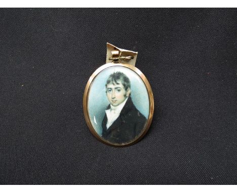 A 19th Century oval bust length portrait miniature paintied on ivory of a gentleman; locks of hair to the reverse, 7cm x 6cm