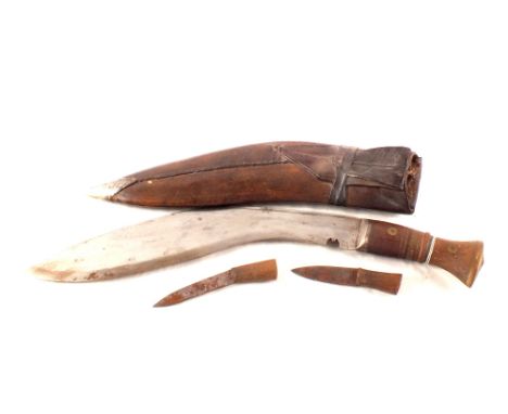 A Kukri in leather scabbard