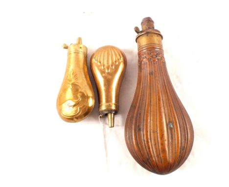 A copper powder flask by Hawksley with two brass pistol flasks (one as found)