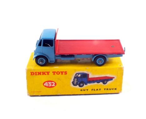 A boxed Dinky Toys 432 Guy flat truck, in light blue chassis and hubs and red bed