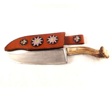 An extremely large bowie knife, 20" overall with a 11 1/2" blade and item 'beaded' embellished leather sheath