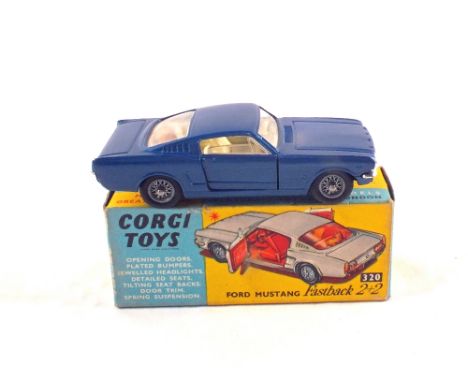 A boxed Corgi Toys 232 Ford Mustang fastback 2+2 in blue and with dog