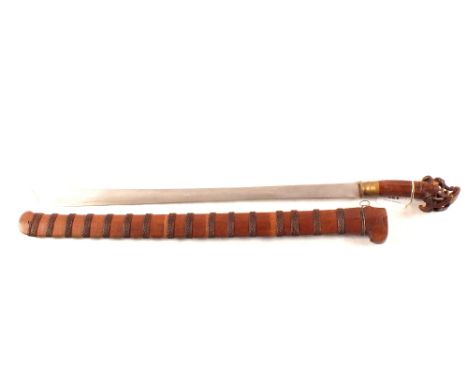 An Indonesian sword carved head grip in wood and braided scabbard