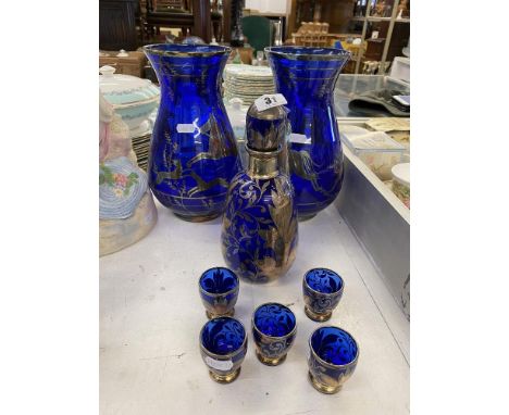 A blue glass decanter and two vases
