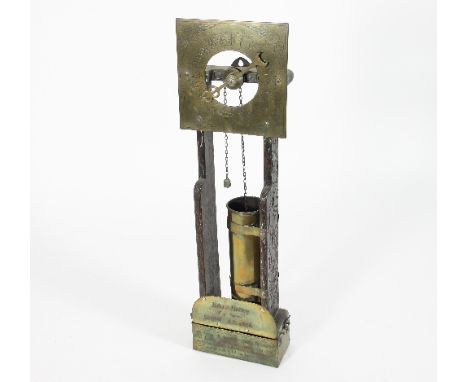 An 'Antiquarian' oak framed 'water clock', surmounted by a square brass dial numbered 1-24 above a cylinder and a plaque insc