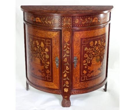 A 19th Century half-round Dutch marquetry commode, fitted two drawers above two panel doors, extensively inlaid with scrolls,