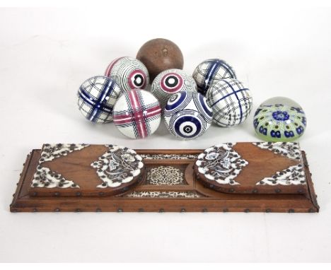 A part set of ceramic carpet bowls comprising seven ceramic balls, two pairs and three singles and a wooden marker ball, an e