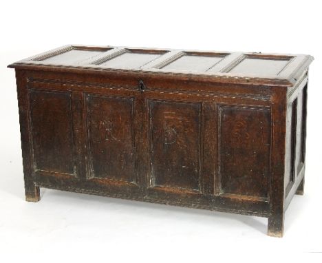 An 18th Century oak chest with quadruple panel hinged top, the front initialled R.D., 141cm wide