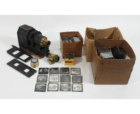 A magic lantern and a quantity of magic lantern slides, varying subjects to include nature shots, colour cartoons, architectu