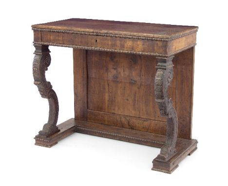 A William IV walnut console table, the rectangular top above a frieze drawer on leaf carved scroll legs and with a panelled b