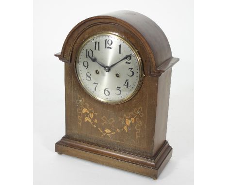 An early 19th Century arch top mantel clock in an inlaid case fitted an eight-day movement striking on a gong, 41cm high
