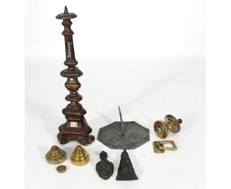 An Italian pricket type altar candlestick, 61cm high, various brass weights, a sundial and other brass items