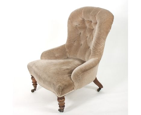 A Victorian button back nursing chair, on turned front legs with castors 