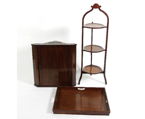 A mahogany corner cupboard, enclosed by a panel door, 51cm wide, a three-tier cake stand and a butlers tray 