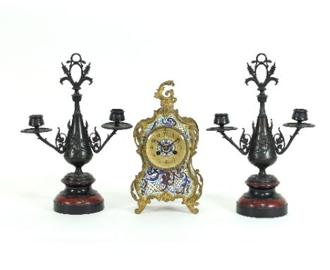 A Continental gilt metal and champlevé enamel mantel clock fitted an eight-day striking movement, 28cm high and two bronzed m