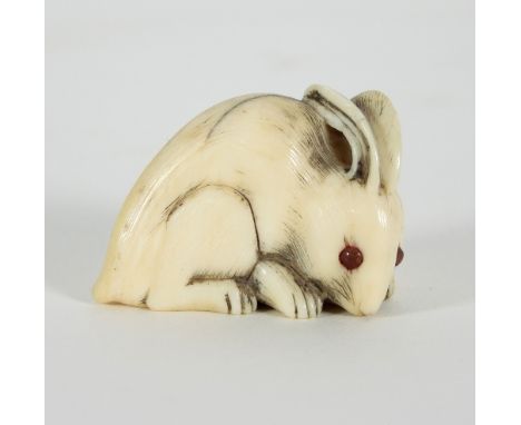 A Japanese carved ivory netsuke, early 19th Century, depicting a rabbit, signed beneath, 3cm high Condition Report: Hair crac