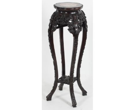 A Chinese hardwood stand, the lobed top with inset marble panel on carved legs united by an undertier, 91cm high Condition Re