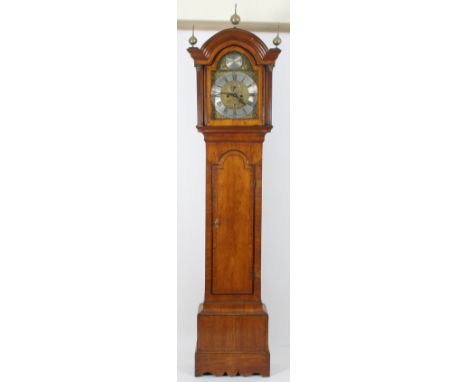 A late 18th Century eight-day longcase clock, the arch top hood with three brass ball finials and fluted columns to the sides