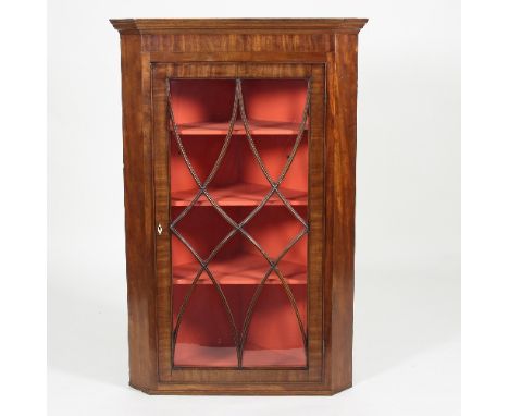 A George III mahogany corner cupboard enclosed by an astragal glazed panel door, 113cm high