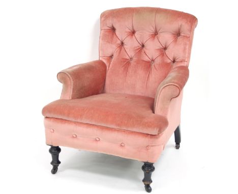 A Victorian armchair with deep button back, upholstered seat and arms, on turned front legs and a pair of Victorian button ba