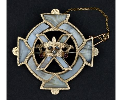 A Scottish polished hardstone brooch, centred by a gem set coronet on a saltire within a Celtic cross border, 5cm wide 
