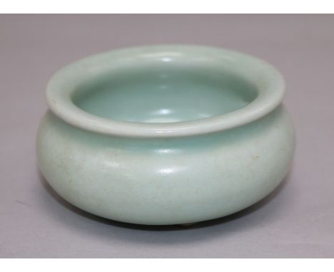 A Chinese Celadon glazed tripod censer