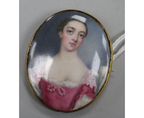 A yellow metal mounted porcelain oval brooch decorated with a portrait of a lady, 48mm.