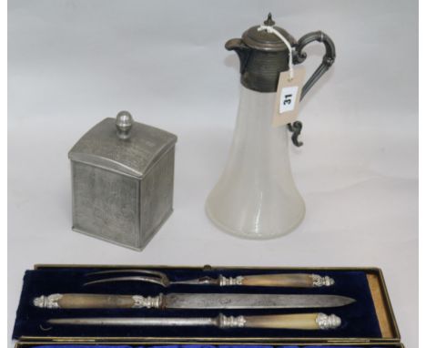 A three piece carving set, claret jug and caddy H 27.5cms