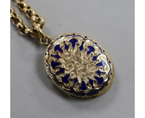 A yellow metal and enamel oval locket on a yellow metal chain.