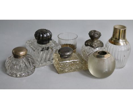 A miniature decanter and cup, a match strike, three inkwells and a perfume bottle.