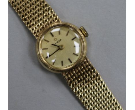 A lady's 9ct Omega manual wind wrist watch on integral Omega 9ct gold bracelet.