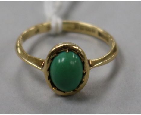 An 18ct gold and oval green cabochon ring, size K.