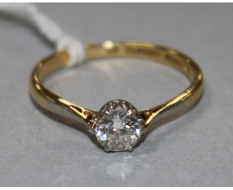 An 18ct gold, platinum and solitaire diamond ring, size M.