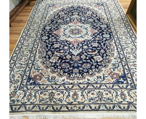 A Nain silk inlaid carpet, 295cm x 200cm.