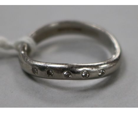 A modern platinum and five stone diamond ring, size M.